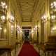 L�ambiente, illuminato da candelabri a parete, � scandito da panche e divanetti in tessuto...